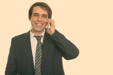 Studio shot of young handsome Persian businessman in suit