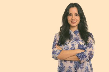 Studio shot of young beautiful Hispanic woman with wavy hair 