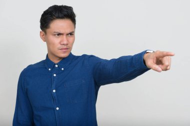 Studio shot of handsome Filipino businessman against white background