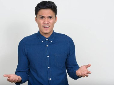Studio shot of handsome Filipino businessman against white background