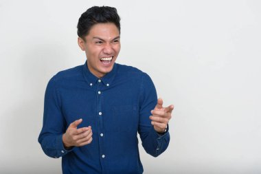 Studio shot of handsome Filipino businessman against white background