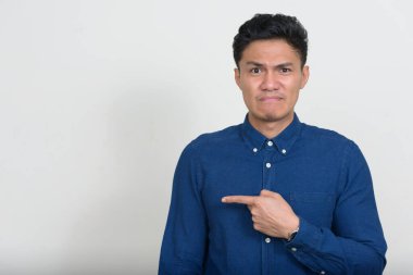 Studio shot of handsome Filipino businessman against white background