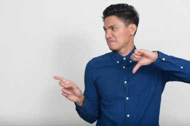 Studio shot of handsome Filipino businessman against white background