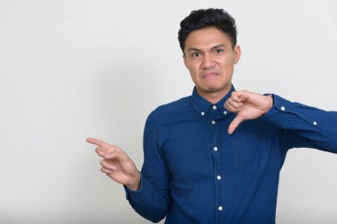 Studio shot of handsome Filipino businessman against white background