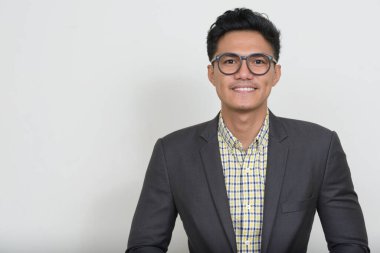 Studio shot of handsome Filipino businessman in suit against white background