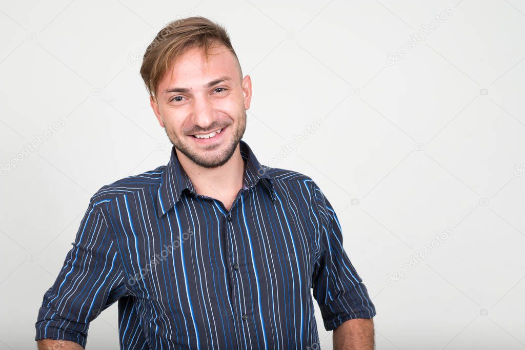 Studio shot of bearded businessman with blond hair against white background