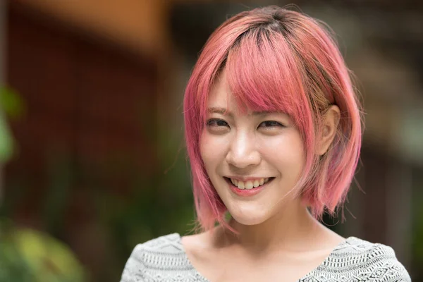 外の通りにピンクの髪の若い美しいアジアの女性の肖像画 — ストック写真