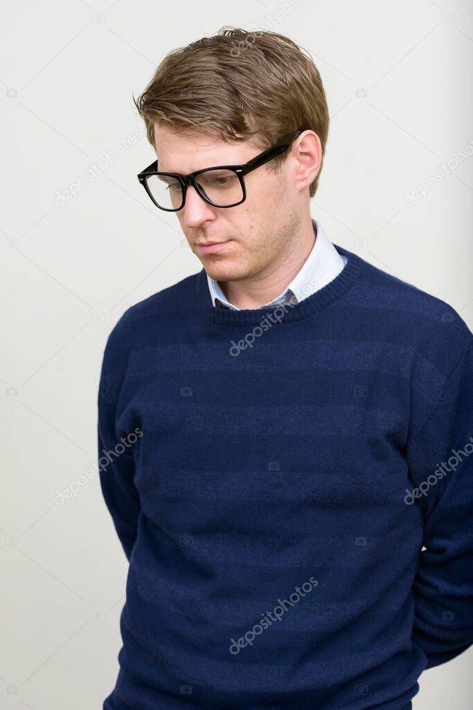 Studio shot of young handsome Scandinavian man  