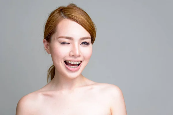 スタジオショットの若い美しい日本の女性の白い背景に恥じらいなく — ストック写真