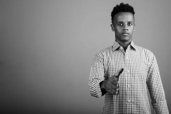 스튜디오에서 잘생긴 아프리카 사업가가 흑백으로 바탕에 체크무늬 셔츠를 — 스톡 사진