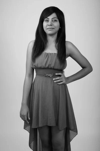 演播室拍摄的年轻波斯女人穿着黑白相间的灰色背景衣服 — 图库照片