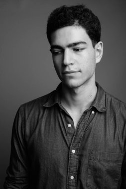 Siyah beyaz gri arka planda genç ve yakışıklı İranlı işadamının stüdyo çekimi