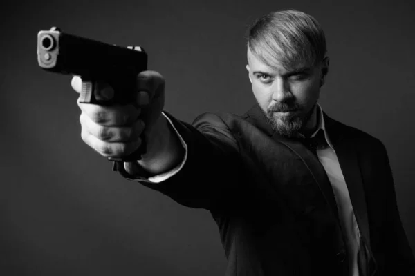 Estudio Plano Hombre Negocios Barbudo Con Pistola Sobre Fondo Gris —  Fotos de Stock
