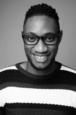 Kenyalı yakışıklı Afrikalı genç adamın, siyah beyaz gri arka plandaki çekimlerine karşı.