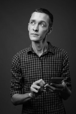 Genç hippinin siyah beyaz gri arka plana karşı atölye çekimi