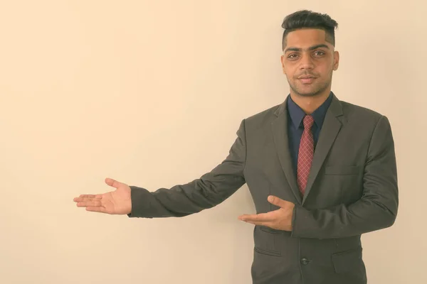 Studio Shot Young Indian Businessman Wearing Suit While Showing Something — Stock Photo, Image
