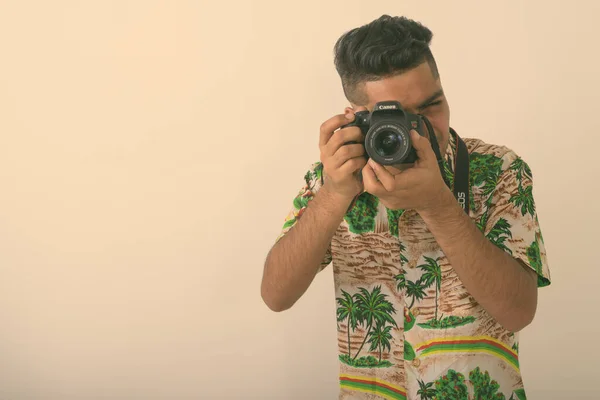 스튜디오는 하와이안 셔츠를 배경에 카메라를 관광객의 사진을 찍었다 — 스톡 사진