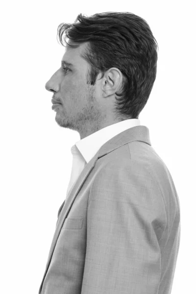 黒と白の白い背景を背景に隔離された訴訟でひげを剃るハンサムなビジネスマンのスタジオショット — ストック写真