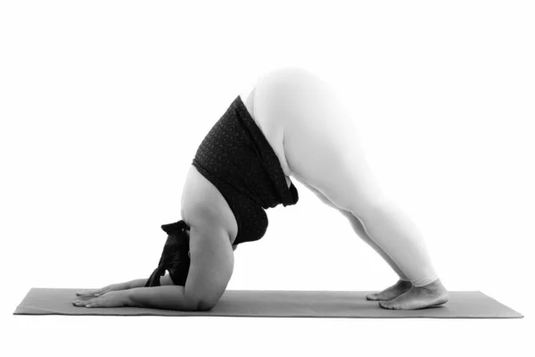 Portrait of adult Yoga teacher practicing advanced yoga standing