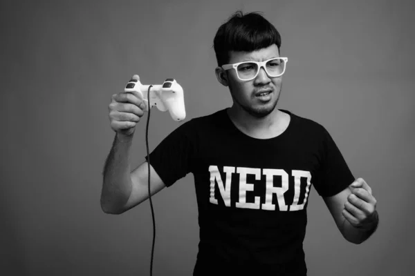 Studio Shot Young Asian Nerd Man Wearing Eyeglasses While Playing — Stock Photo, Image