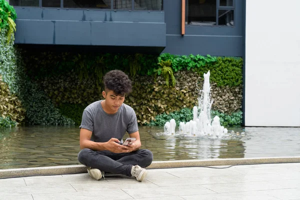 Portrait Young Asian Man Curly Hair Sitting Modern Building City — Stock Photo, Image