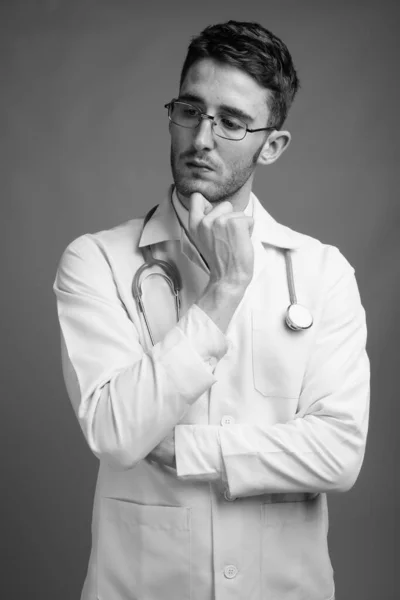 Studio Shot Young Handsome Man Doctor Wearing Eyeglasses Gray Background — Stock Photo, Image