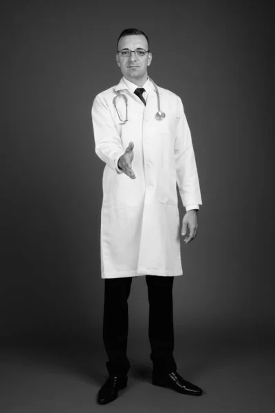 Studio Shot Του Άνδρα Γιατρό Φορώντας Γυαλιά Έναντι Γκρι Φόντο — Φωτογραφία Αρχείου