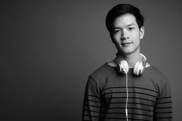 Estudio Joven Guapo Asiático Escuchando Música Sobre Fondo Gris Blanco —  Fotos de Stock