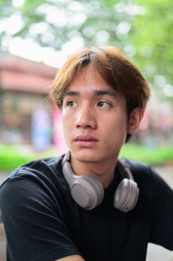 Modern yaşam tarzı fotoğrafçılığı için poz veren Taylandlı genç bir adamın portresi. Çeşitli kavramlar ve kullanımlar için kendine güvenen, rahat ve otantik görünüm