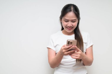 Sıradan beyaz tişört giyen Asyalı genç bir kadının stüdyo portresi.