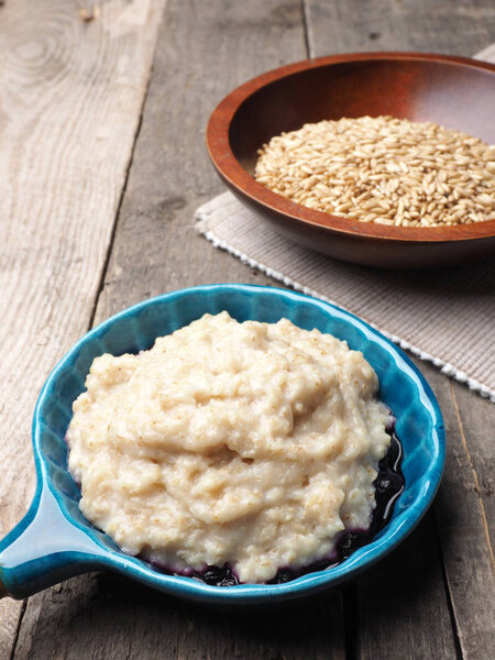 Tasty organic porridge in a blue bowl