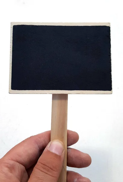 Hand holding a chalkboard sign — Stock Photo, Image