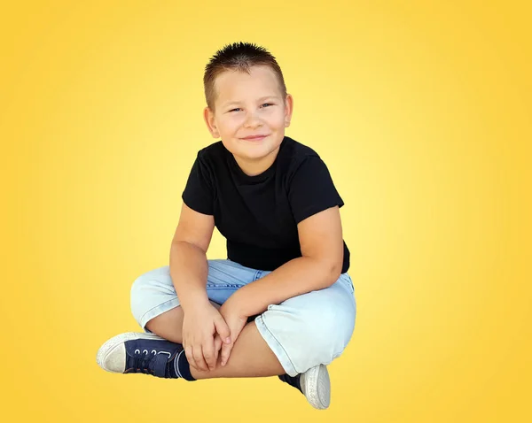 Adorable little boy sitting on floor — Stock Photo, Image