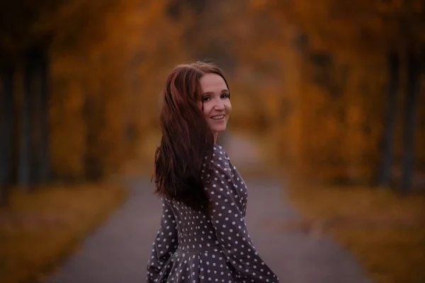 girl walks in autumn park