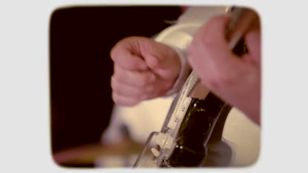 The hand touches the strings on an electric guitar. 8mm retro style film. — Stock Video