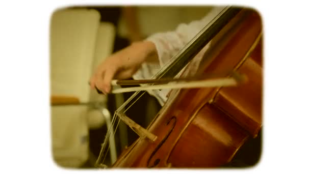 Female hand with a bow plays on a double bass. 8mm retro style film. — Stock Video