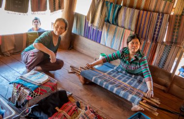 , laos - november 24, 2018: woman at the loom clipart