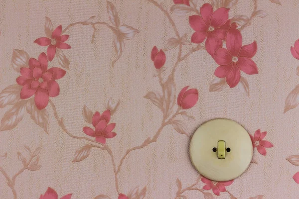 Old wallpaper with light switch — Stock Photo, Image