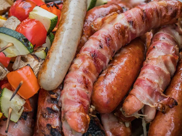 Sausages and vegetables on a grill — Stock Photo, Image