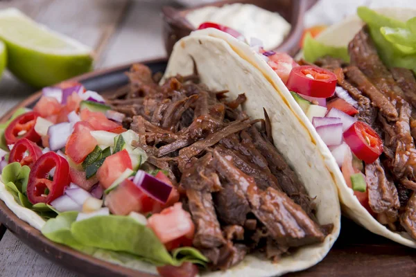 Mexican tacos with roasted beef ,sauce and salsa tomato