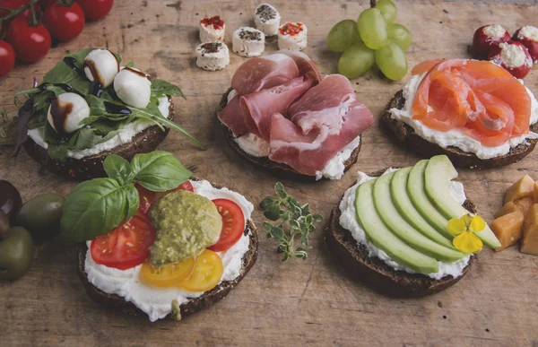 Canape Salmon Prosciutto Avocado Mozzarella Tomato Pesto Olives Cream Cheese — Stock Photo, Image