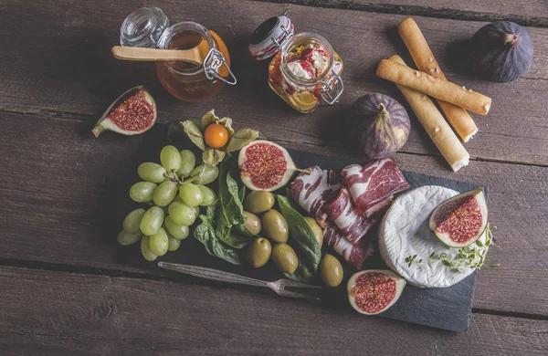 Prosciutto Camembert Cheese Figs Honey Grapes Olives Dark Serving Board — Stock Photo, Image