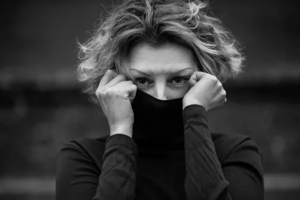 Beautiful woman with short hair wearing black turtleneck Stock Picture