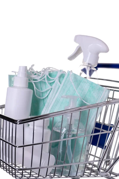 Shopping cart filled with different kinds of desinfectants on white background — Stock Photo, Image