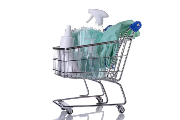 Carrinho de compras cheio de diferentes tipos de desinfetantes em fundo branco — Fotografia de Stock