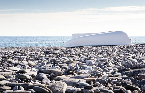 Båt på stenig strand — Stockfoto