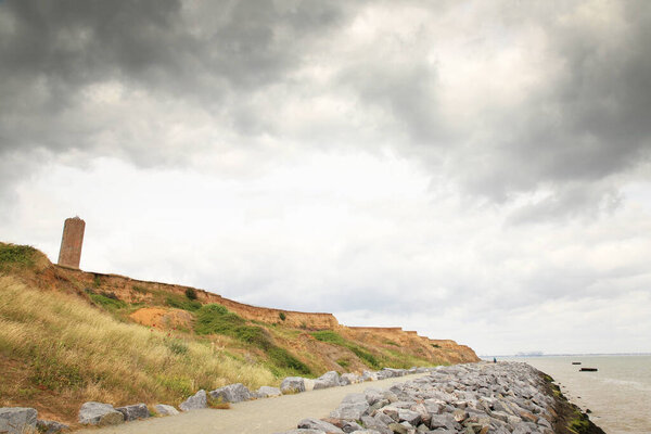 sea wall pathway defence along the seafront with the naze tower in the background