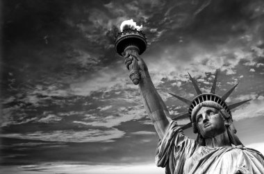 Statue of Liberty, dramatic sky background. New York City, USA