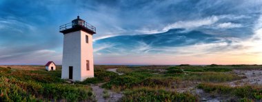 Wood End lighthouse during sunset in Provincetown, Massachusetts, USA. Panoramoc view clipart