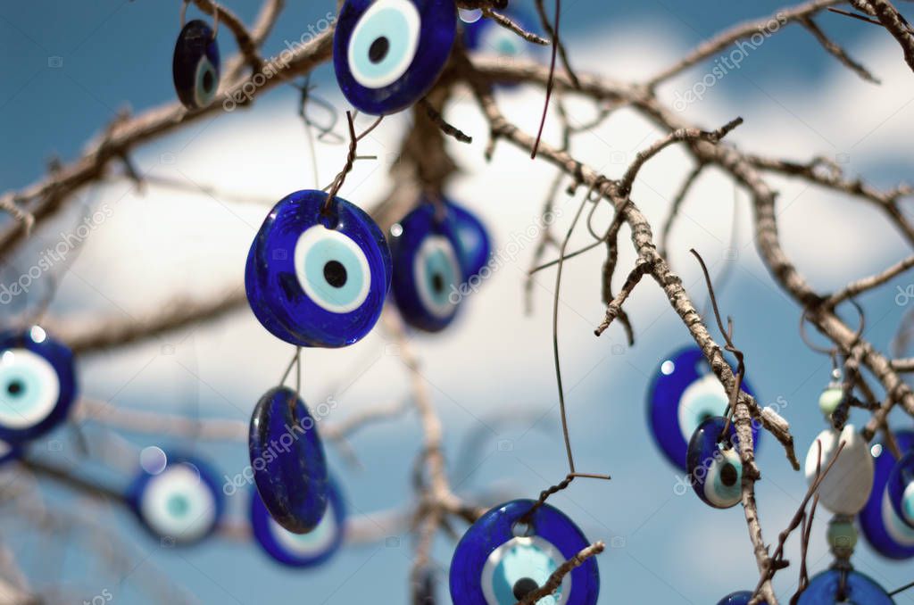 Nazar, charms to ward off the evil eye , on the branches of a tree in Cappadocia, Turkey